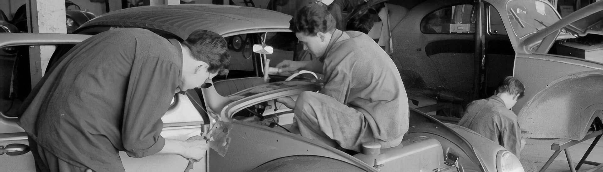 men-looking-at-working-on-car-fixing