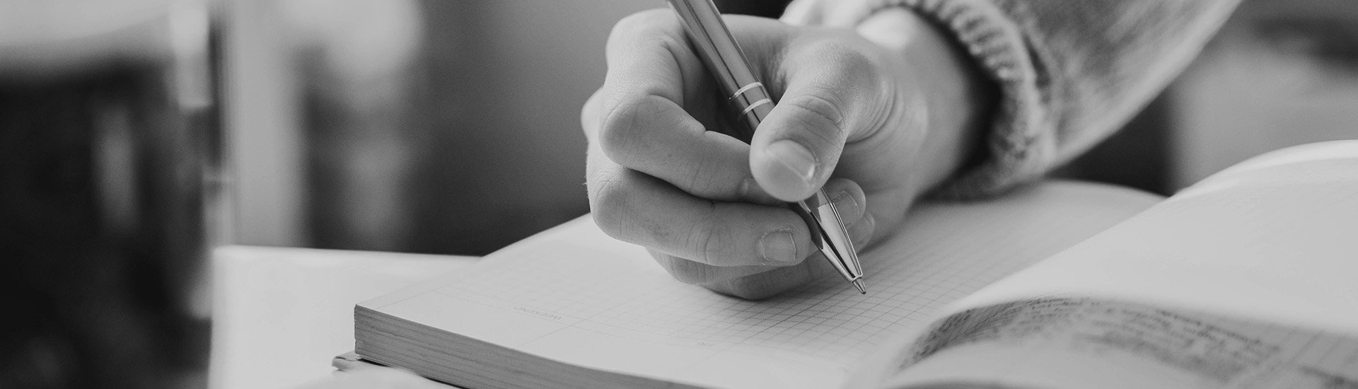 person-writing-in-notebook